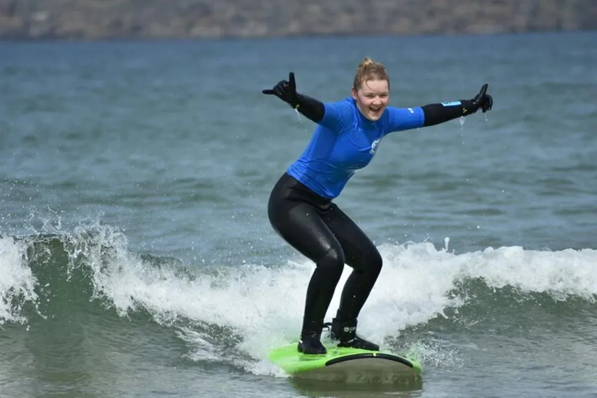 a woman riding a wave on a surfboard in the ocean