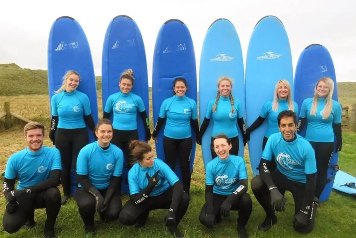 a group of people posing for a picture with surfboards