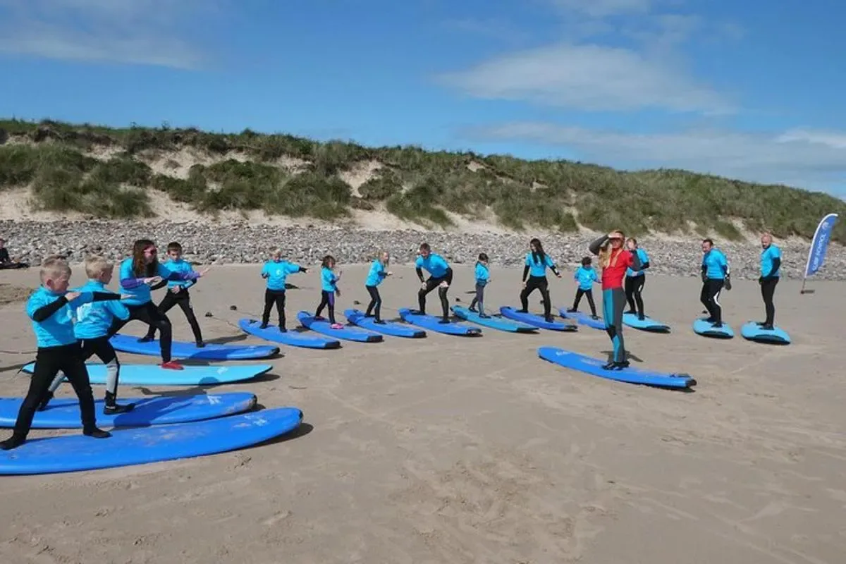 a group of people on surfboards on a beach