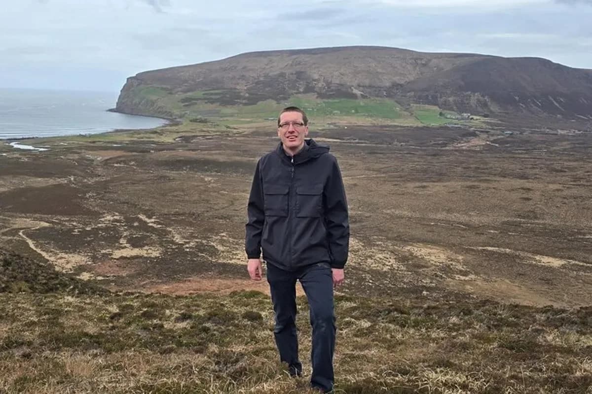 a man standing on top of a hill