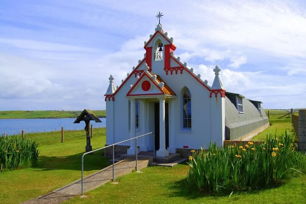 a small church with a cross on top of it
