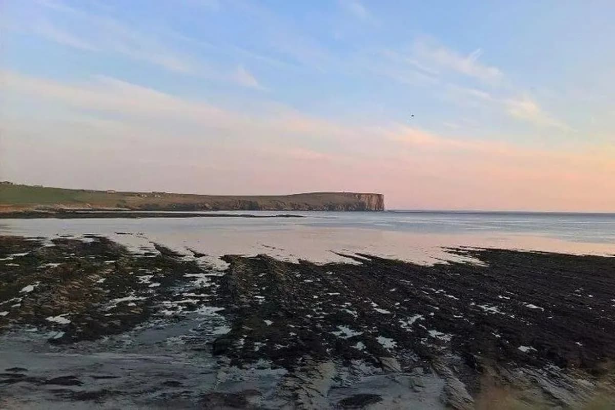 a view of the ocean with a rocky beach