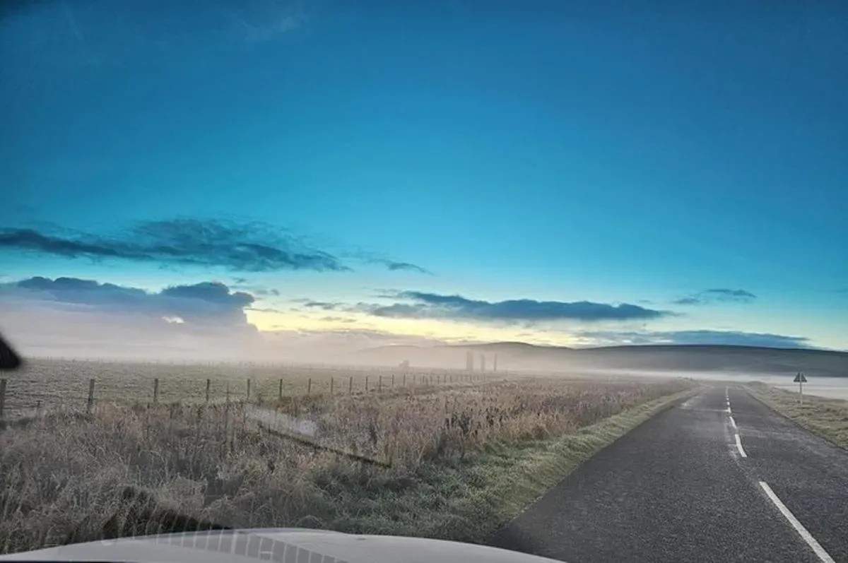 a view of a road in the middle of a field