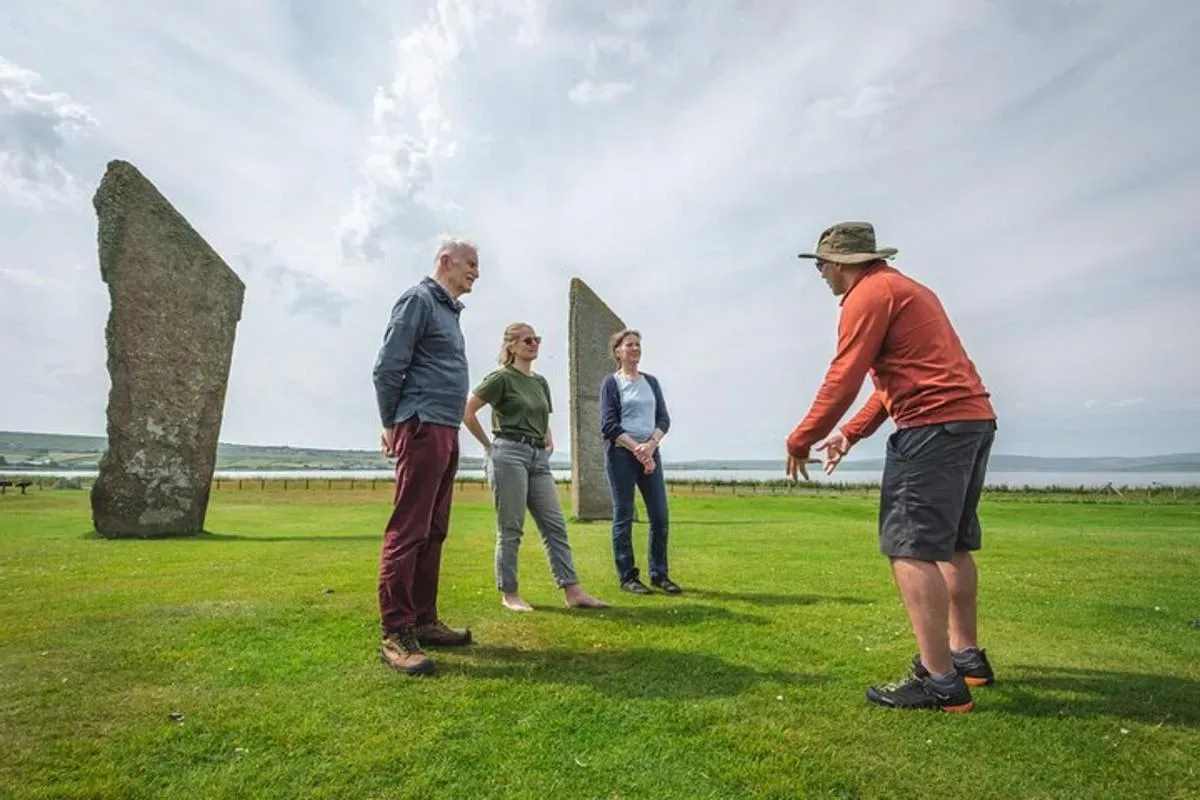 a group of people standing in front of a sculpture