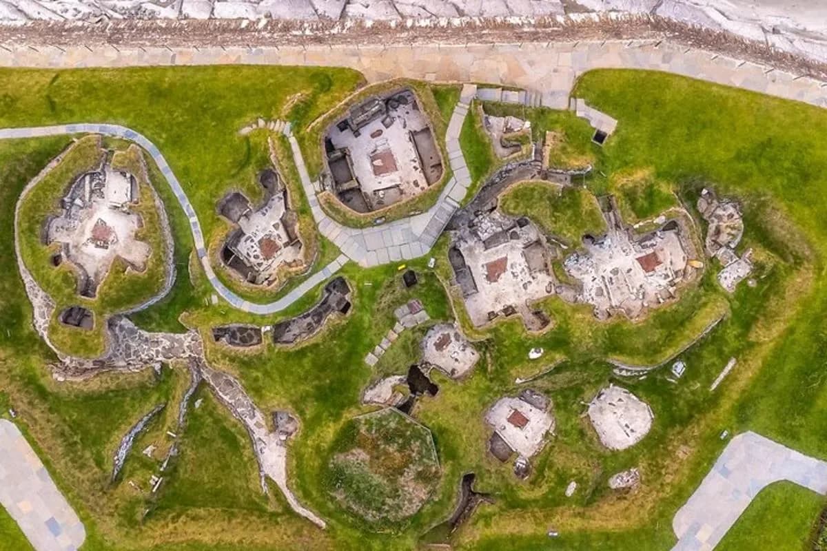 an overhead view of an old mansion on a grass field