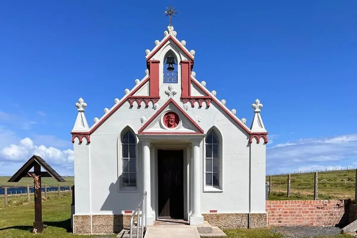 a small white church with a cross on top of it