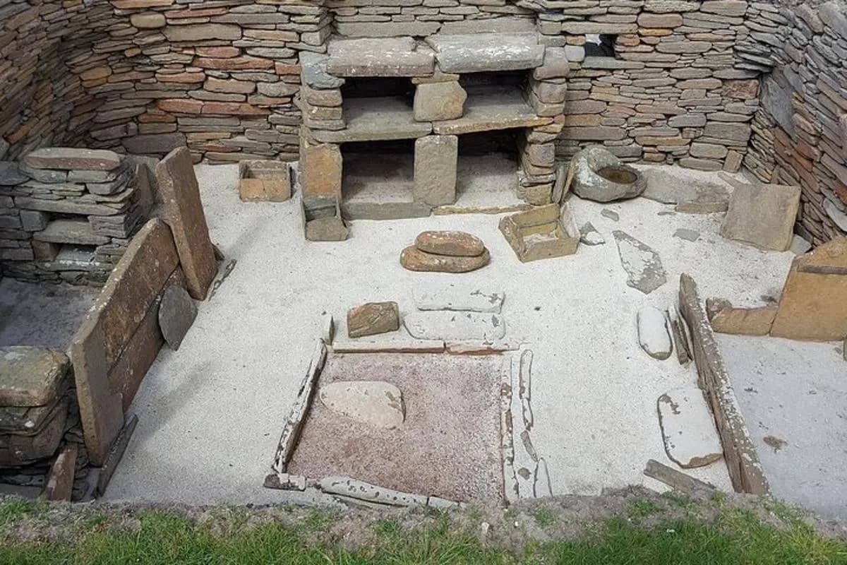 a stone building with a hole in the ground