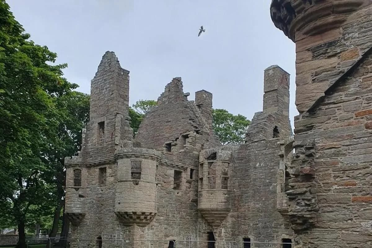an old stone building with towers on top of it