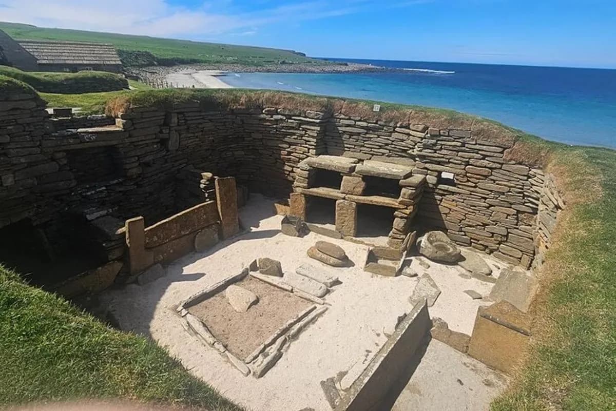 an ancient building on the side of a beach