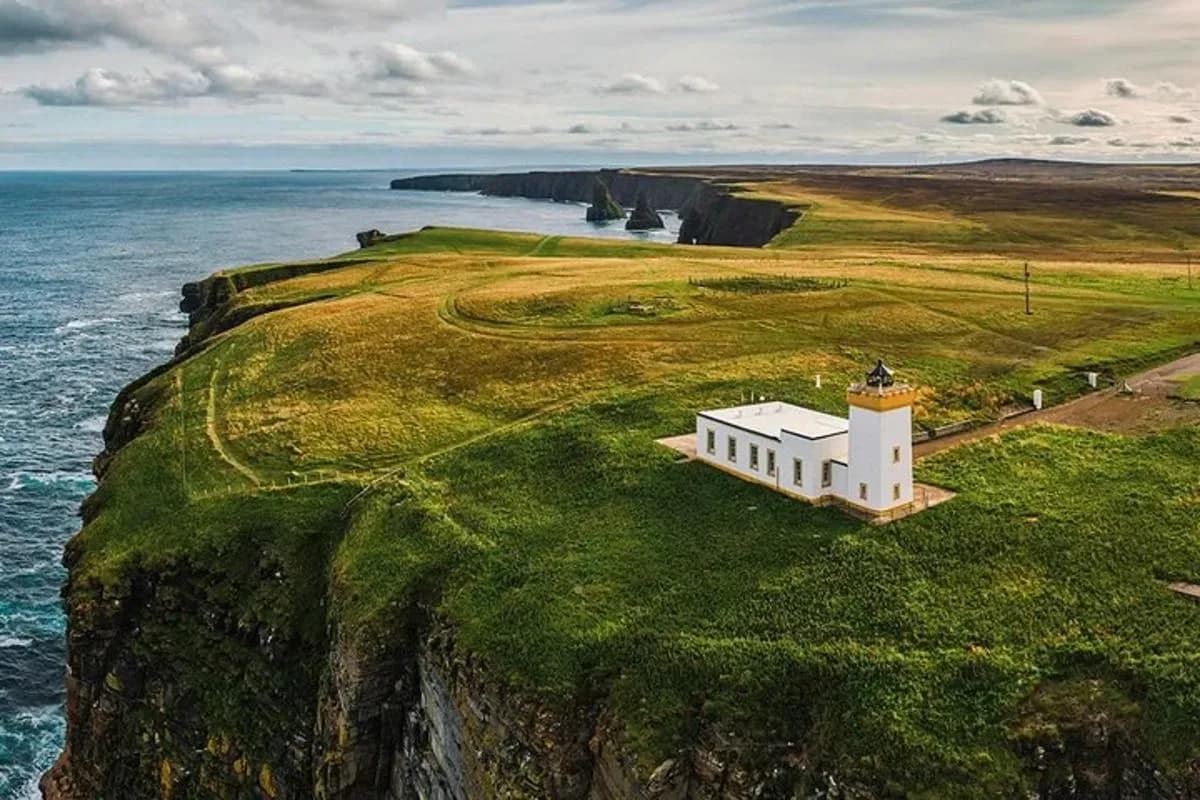 a building on a cliff next to the ocean