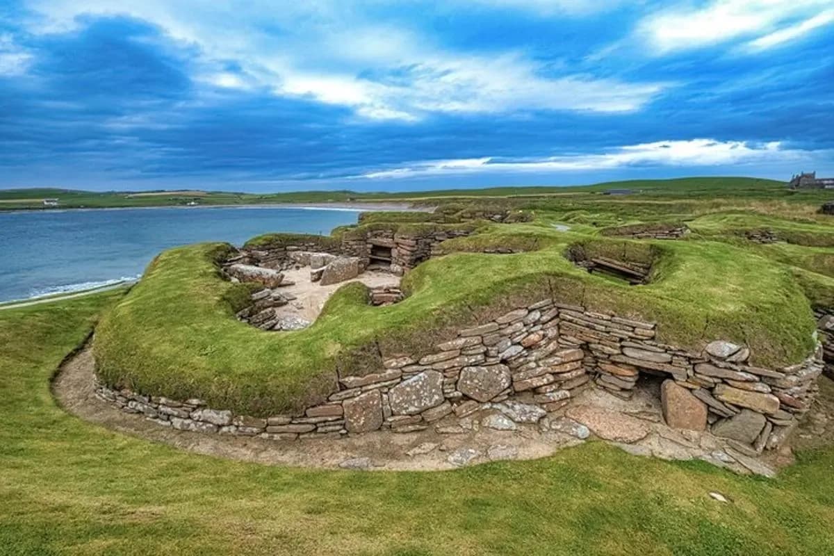 an old stone building next to a body of water